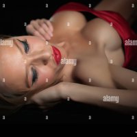 Sexy woman with big boobs lying on her back Stock Photo