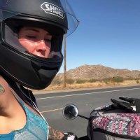 felicity feline riding on aprilia tuono motorcycle