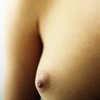 Womans bare breast close-up.