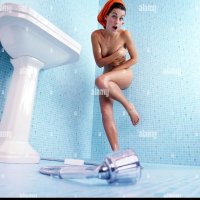 Bathroom naked woman hidding her breasts with her hands embarrassed Stock Photo
