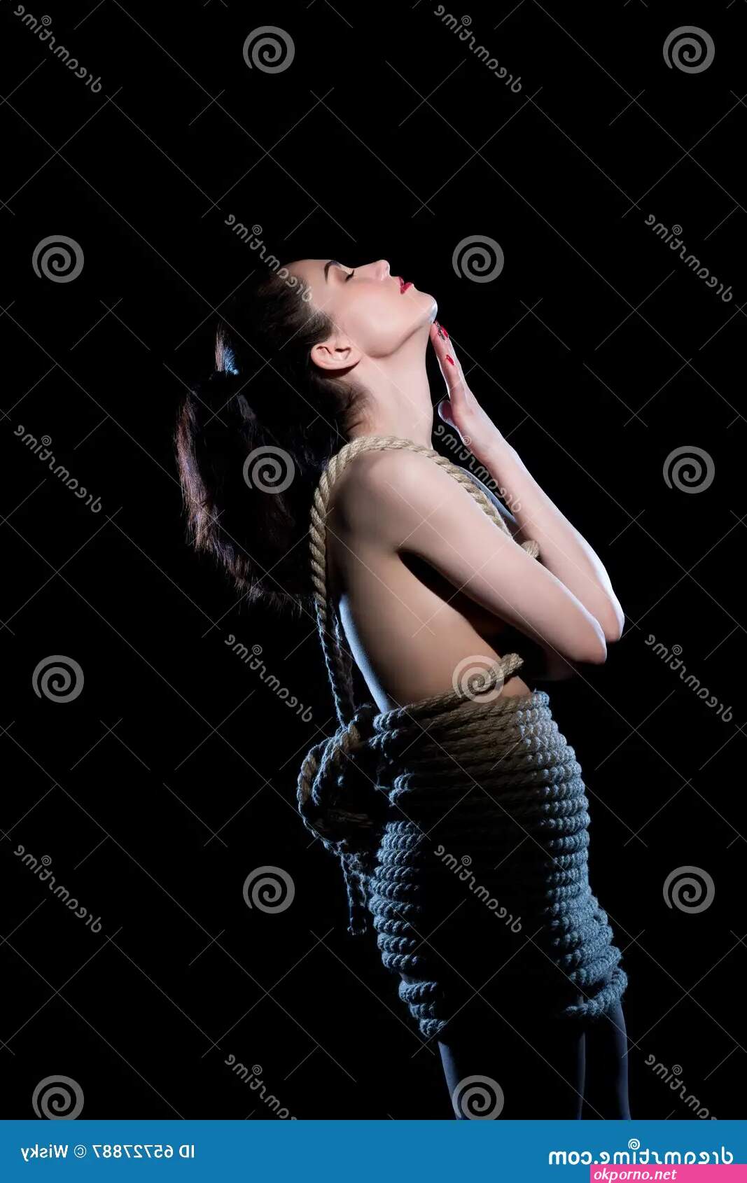 Skinny girl tied up and hanged up on a rope